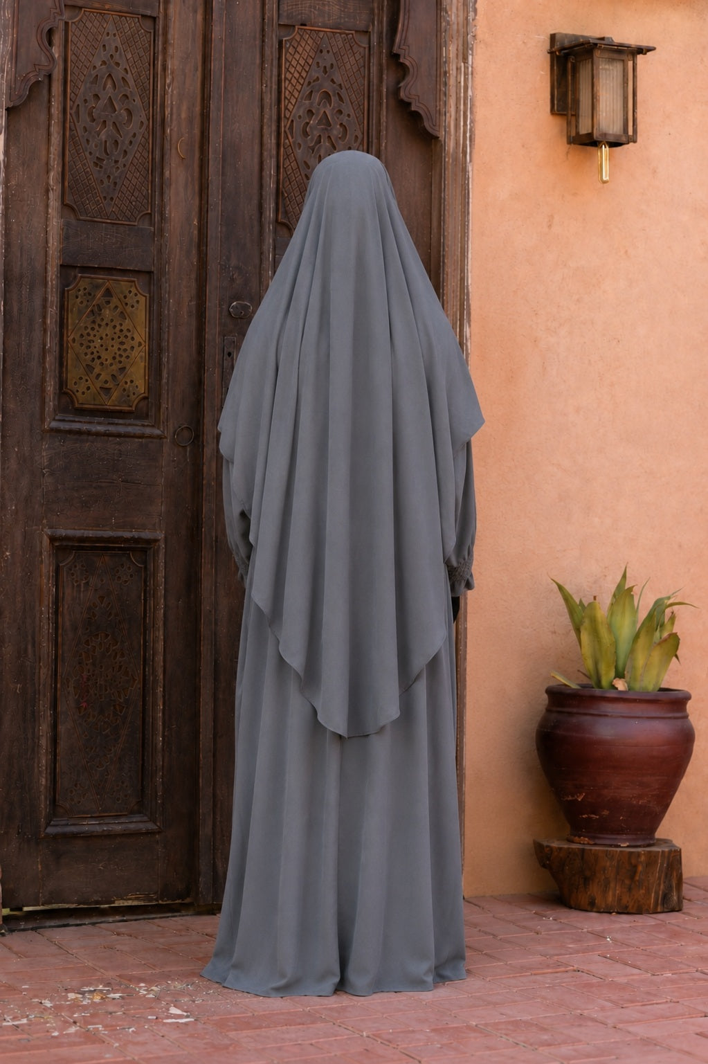 Vue arrière d'un jilbab 2 pièces gris en crêpe royal avec khimar long couvrant et coupe ample, offrant une silhouette élégante et mastour.